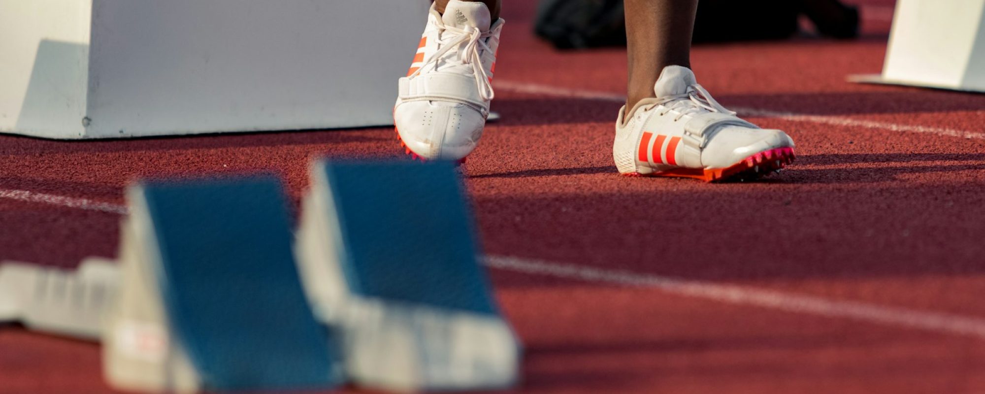 person standing beside white stand