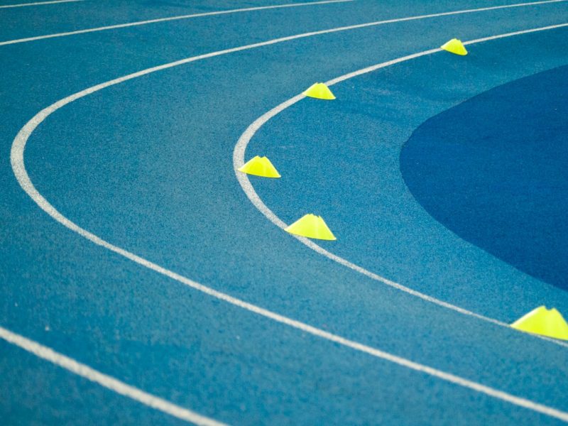 blue curved track field at daytime