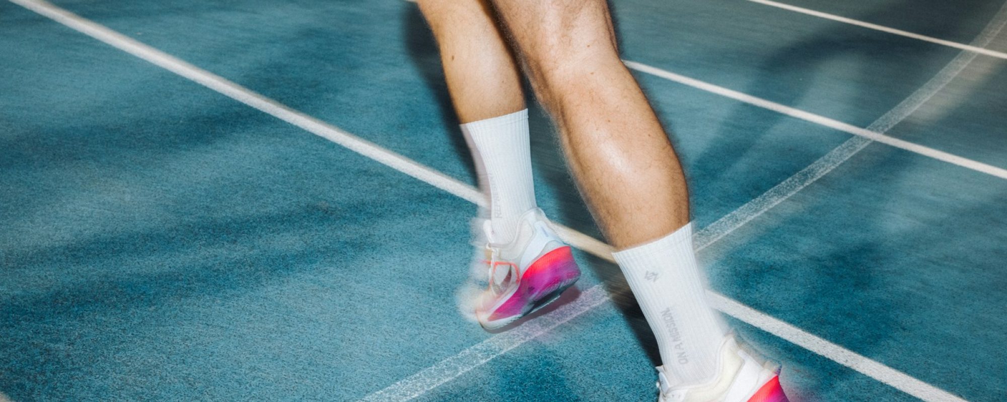 Runner's legs moving swiftly on a track.